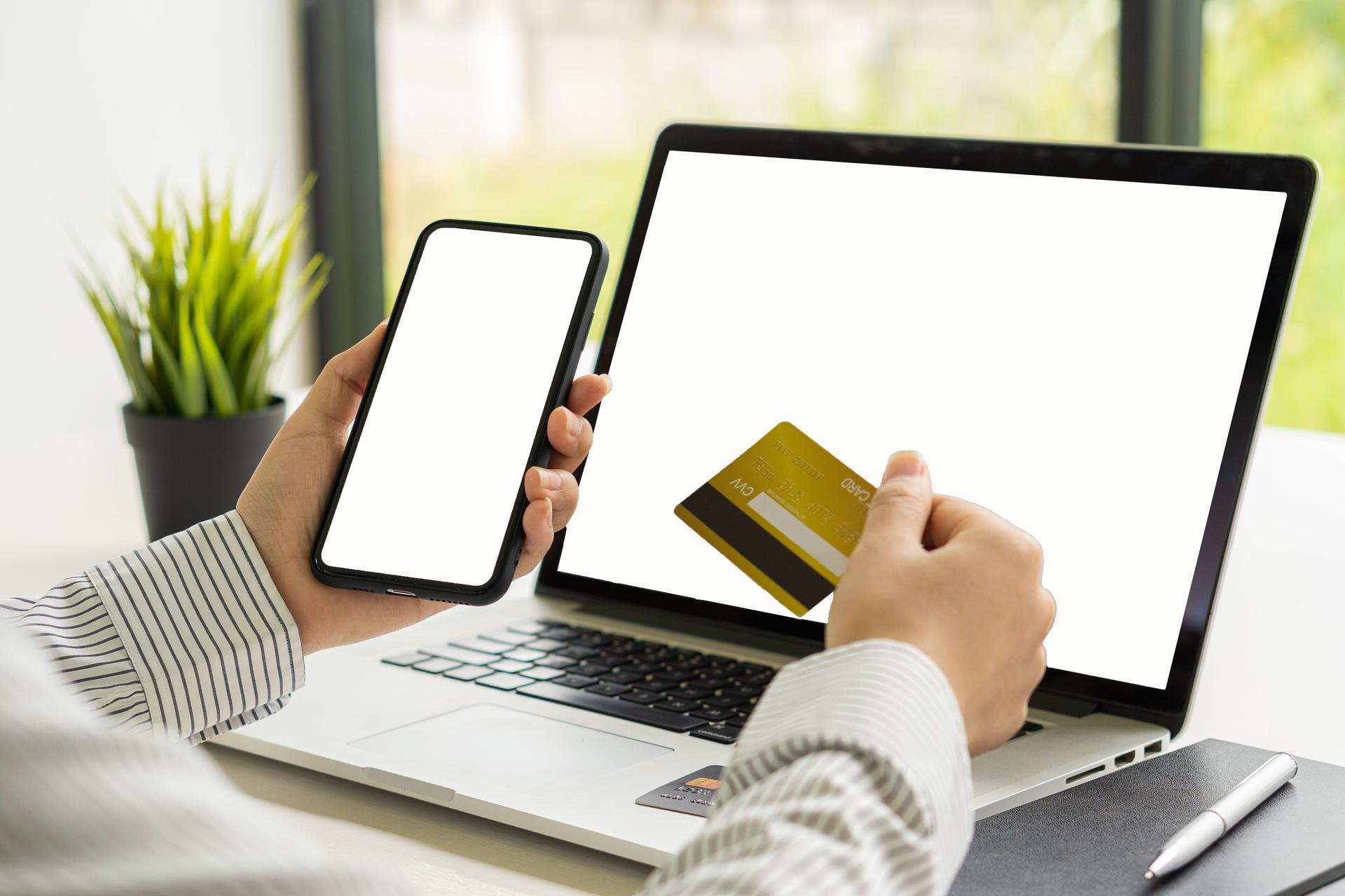 female hand holding credit card Use smartphone with white screen, shop online, pay online, internet payment concept.